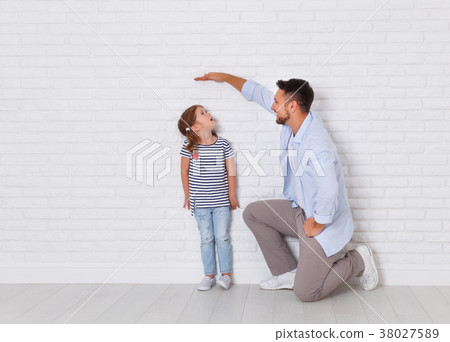 concept of the family. the father measures growth of child to da concept of the family. the father measures growth of child to da 38027589