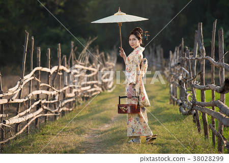 Japanese women wear kimono holding umbrellas  38028299