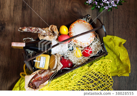 Colorful easter eggs in a basket with cake, red Colorful easter eggs in a basket with cake, red 38028555
