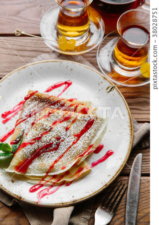 Delicious thin pancakes served with strawberry 38028751