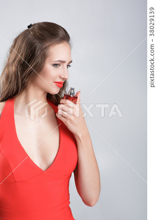 woman in red dress with perfume 38029139