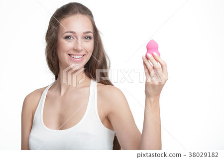 woman holding a beauty blender woman holding a beauty blender 38029182
