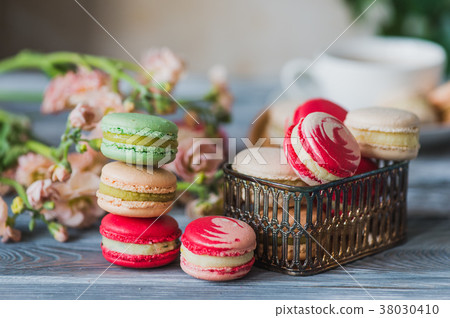 traditional french colorful macarons in a rows in 38030410