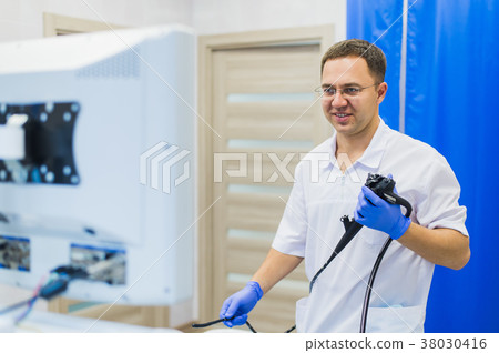 proctologist doctor holding Ligador hemorroidal in 38030416