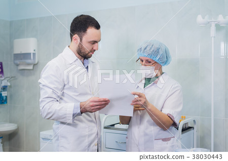 Young and senior chemists working together and 38030443