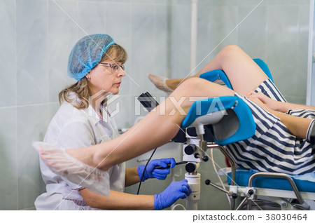 Senior female positively gynecologist examining a 38030464