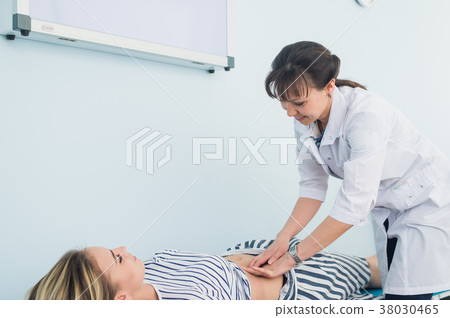 doctor's hands examining female abdomen doctor's hands examining female abdomen 38030465