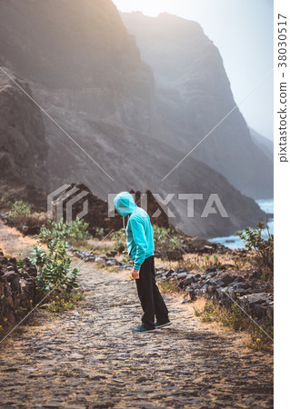 Tourist in hoodie in Aranhas valley hiking to Tourist in hoodie in Aranhas valley hiking to 38030517