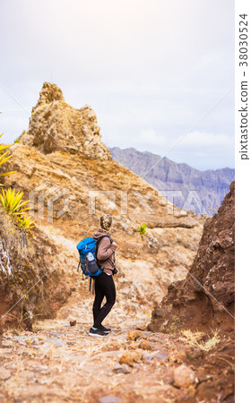 Woman hiker on the stony trekking trail in front Woman hiker on the stony trekking trail in front 38030524