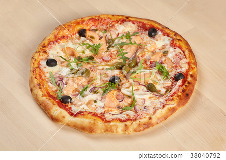 Fresh baked seafood pizza on wooden background Fresh baked seafood pizza on wooden background 38040792