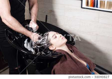 beautiful girl washes her hair before a haircut in 38040827