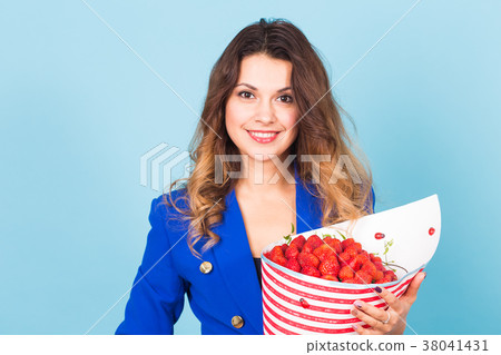 Young woman holding bouquet of strawberries on Young woman holding bouquet of strawberries on 38041431