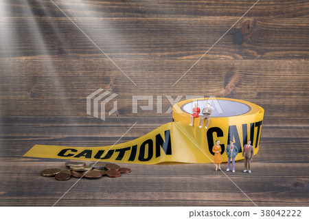 insurance business, financial success. yellow caution tape on a wooden background 38042222