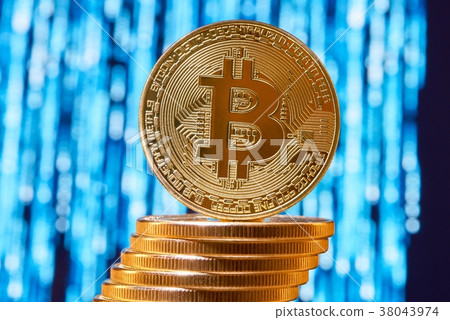 One bitcoin on edge placed on stack of golden One bitcoin on edge placed on stack of golden 38043974