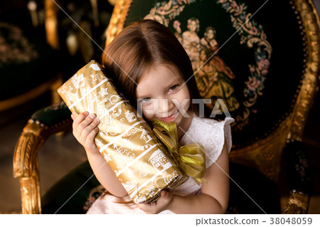 little smiling girl with christmas gift box. little smiling girl with christmas gift box. 38048059