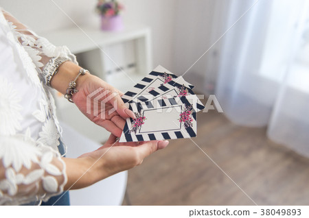 The girl shows patterned gift certificates The girl shows patterned gift certificates 38049893