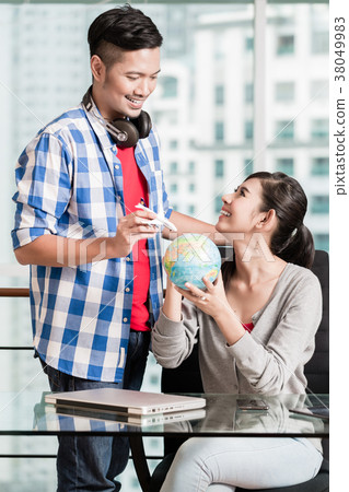 Asian couple with globe and model airplane in Asian couple with globe and model airplane in 38049983