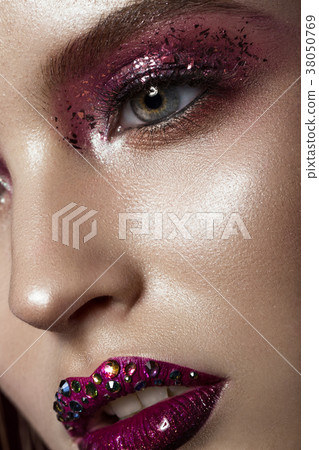 Beautiful girl with creative bright makeup with 38050769