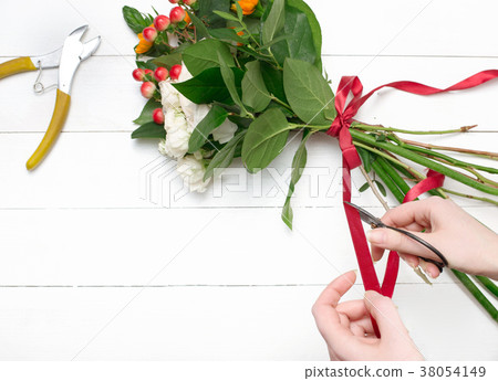Female florist making beautiful bouquet at flower Female florist making beautiful bouquet at flower 38054149
