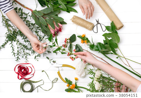 Female florist making beautiful bouquet at flower Female florist making beautiful bouquet at flower 38054151