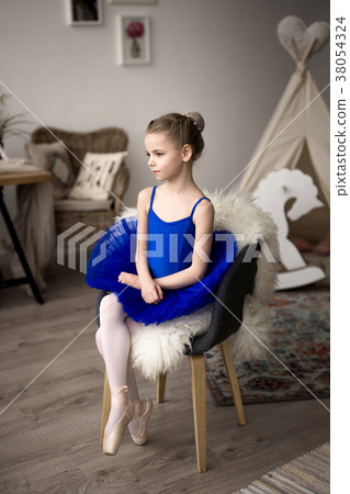 girl in a blue ballet costume dancing in a room. 38054324