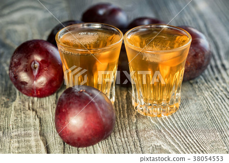 Plum brandy or slivovitz with fresh and tasty plum 38054553