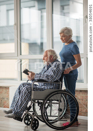 Tranquil pensioners spending time together at home Tranquil pensioners spending time together at home 38054691
