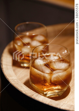 Glass of whiskey on wooden background close up Glass of whiskey on wooden background close up 38055578