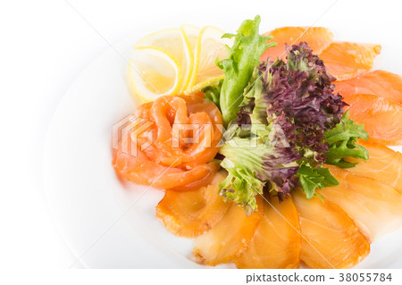Assorted fish on a plate with lettuce and lemon on 38055784