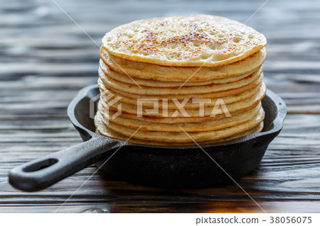 Stack of pancakes in a cast iron pan. Stack of pancakes in a cast iron pan. 38056075