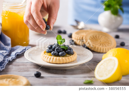 Lemon curd tartlet with fresh blueberries 38056555