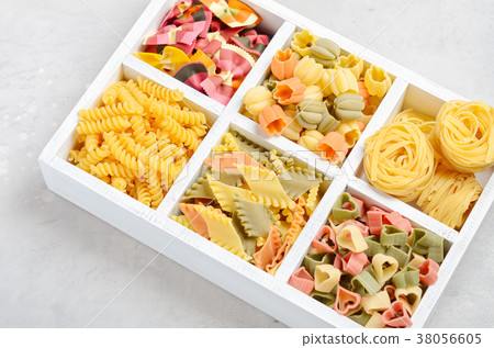 Variety of types and shapes of raw Italian pasta.  38056605