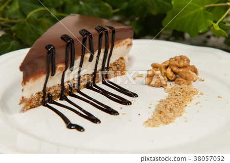 Slice of homemade walnut cake with chocolate Slice of homemade walnut cake with chocolate 38057052