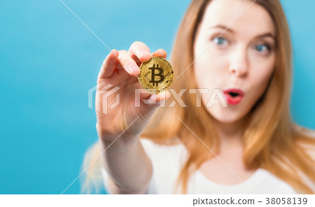 Woman holding a physical bitcoin 38058139