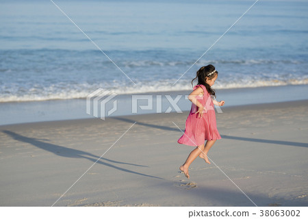 Girls playing on the beach 38063002