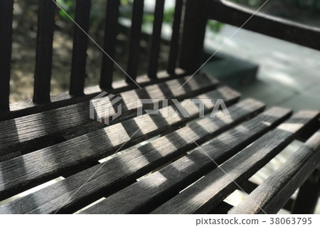Garden dark brwon wooden bench with light, shadow Garden dark brwon wooden bench with light, shadow 38063795