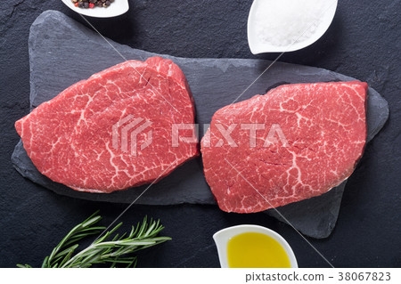 Raw beef steak with rosemary 38067823