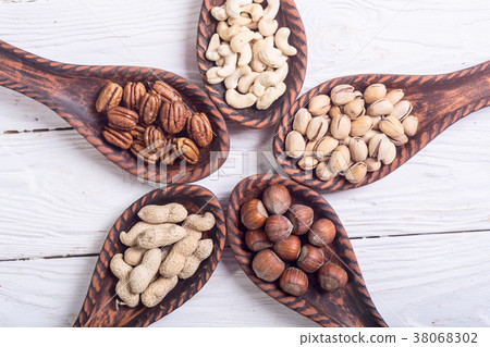 Mix of nuts in wooden spoon 38068302