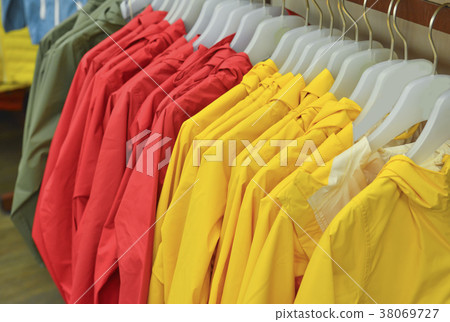 A row of colored jackets on a hanger A row of colored jackets on a hanger 38069727