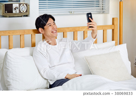 20 Year Old Man In A Bed Chatting With A Lover Stock