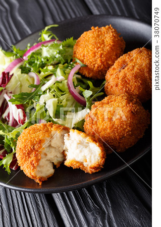 Cod cake in breading with fresh mix salad Cod cake in breading with fresh mix salad 38070749