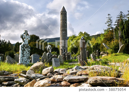 Round tower and semetery in Glendalough, Ireland. Round tower and semetery in Glendalough, Ireland. 38075054