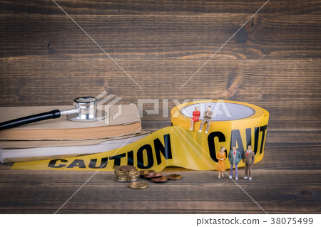 health care and medical background. yellow caution tape on a wood health care and medical background. yellow caution tape on a wood 38075499