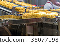 Instant noodles on transmission belt in production 38077198