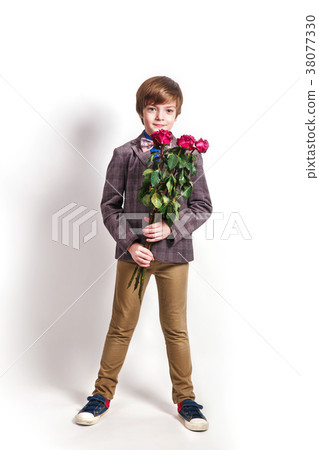 Smiling boy with a bouquet of red roses Smiling boy with a bouquet of red roses 38077330