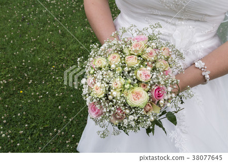 Bride in white satin dress and wedding bouquet Bride in white satin dress and wedding bouquet 38077645