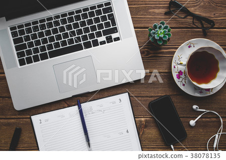 Working place with laptop on wooden table 38078135