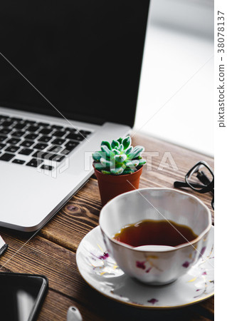 Working place with laptop on wooden table 38078137