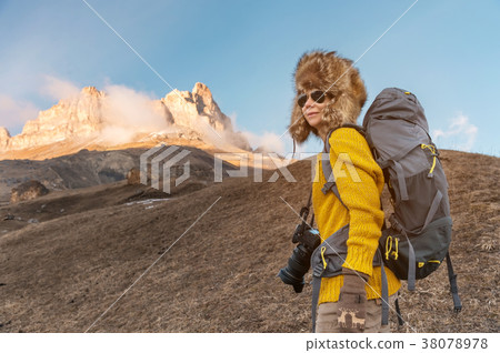 The backpacker girl in sunglasses and a big The backpacker girl in sunglasses and a big 38078978