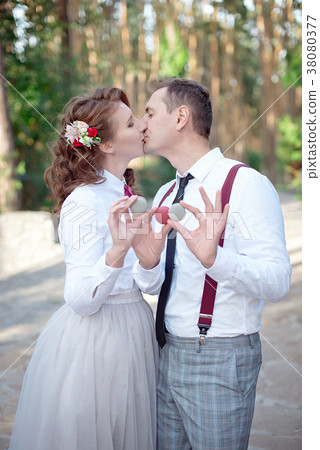 Young couple holding colored macarons on the eyes 38080377